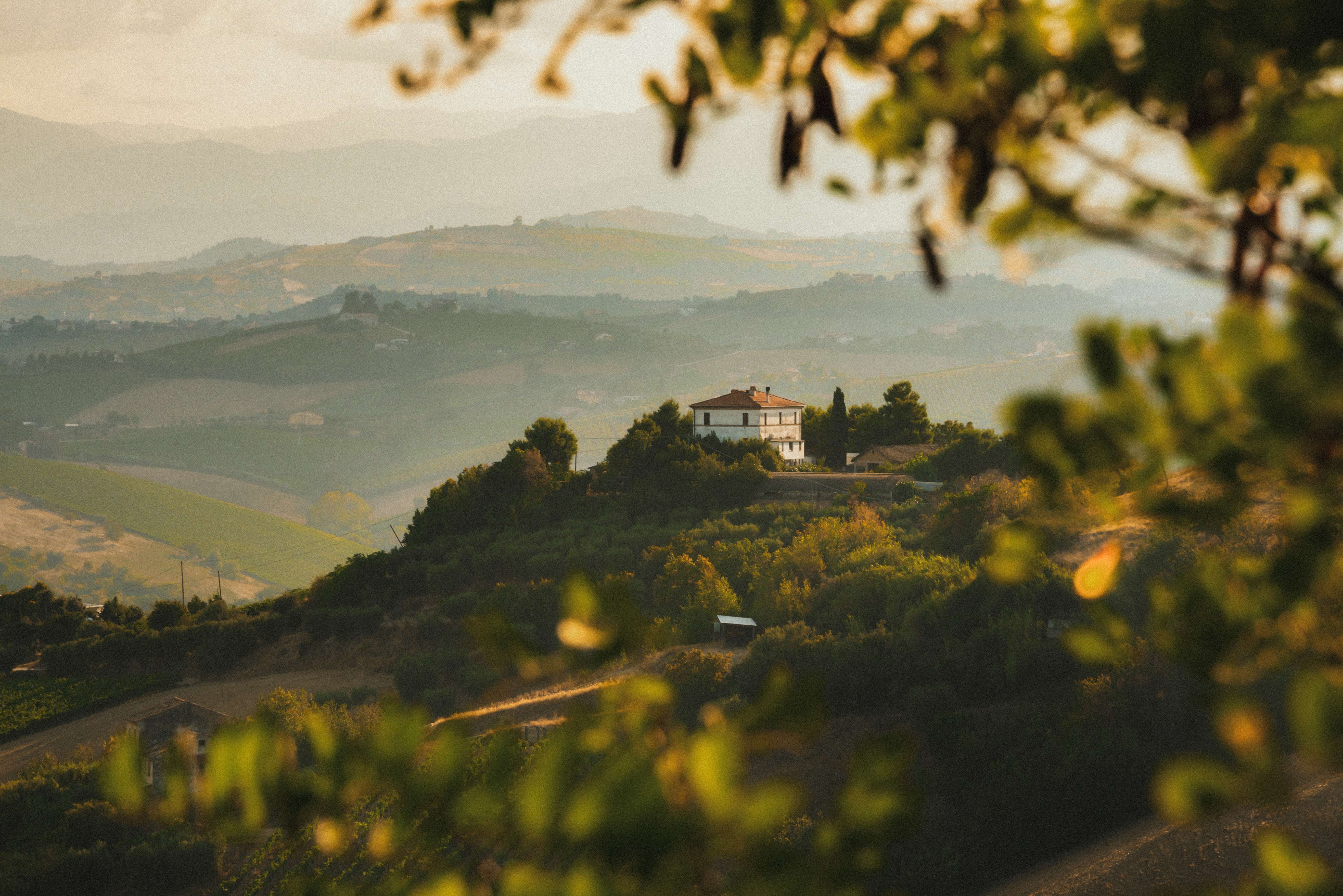 house-on-hill-with-rolling-hills-and-trees-in-france