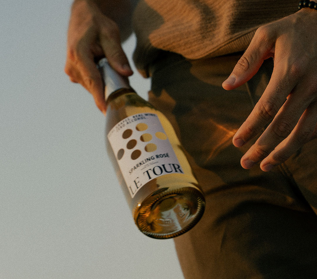 person-holding-bottle-of-le-tour-non-alcoholic-sparkling-rose-wine